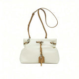 Full front shot of a light white leather MUNI handbag with its shoulder strap extended vertically, from BLUE SALON.