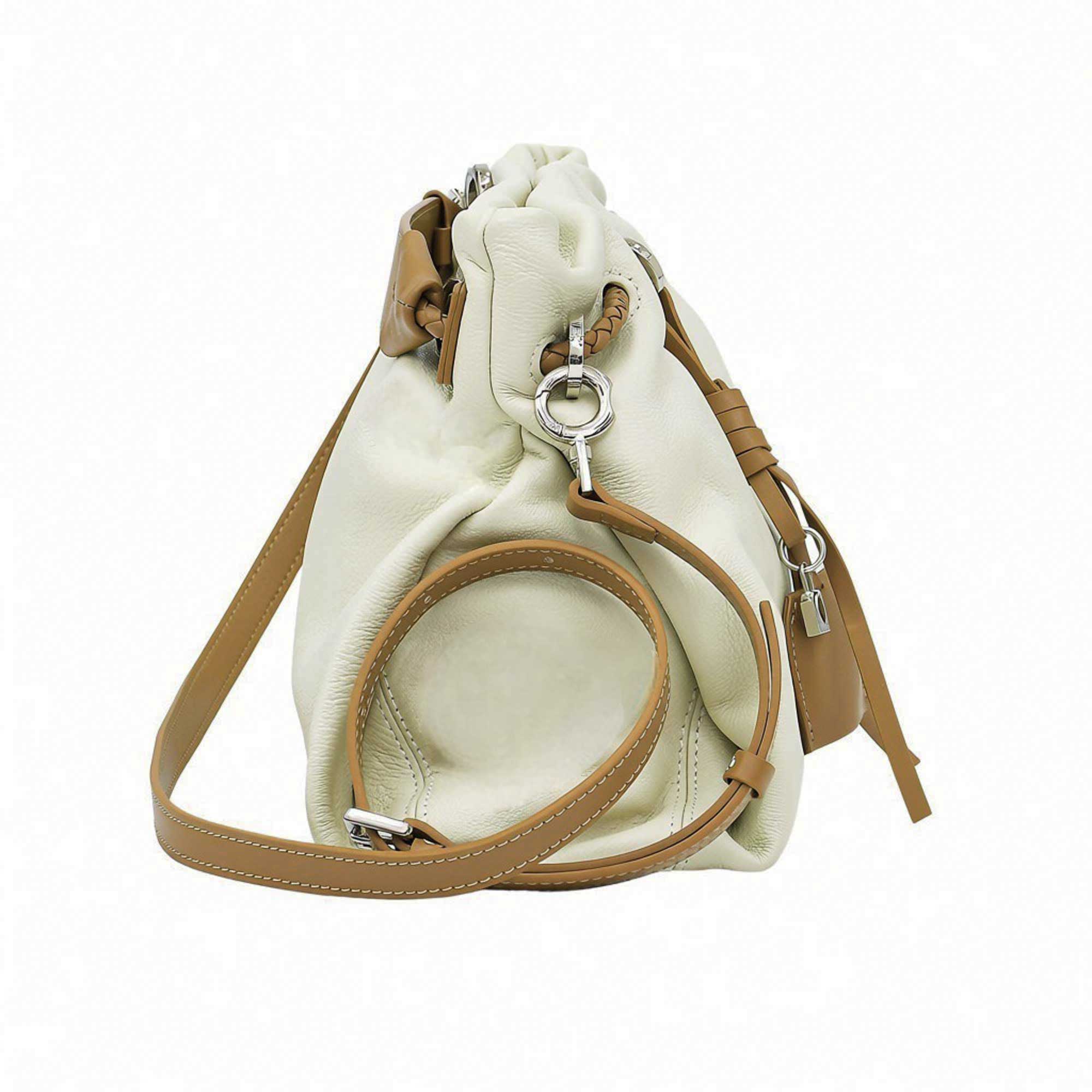 Direct side profile view of a light green leather MUNI bucket-style shoulder bag with visible stitching from BLUE SALON.