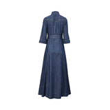 Back studio view of the Nenette dark blue denim maxi shirt dress, showcasing its tailored waistband, western-inspired shoulder yoke, and flared A-line silhouette.