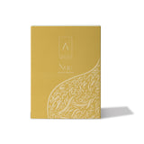 Artist’O Nue Eau de Parfum in an ornate clear glass bottle with golden fragrance tones, displayed with matching luxury packaging – Now Online