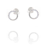 A pair of silver-toned stud earrings, each featuring an open circle design. One arc of the circle is smooth, the other is set