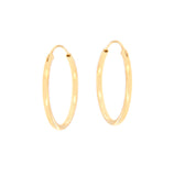 Pair of tiny gold-toned circular hoop earrings with a polished finish.