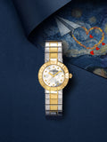 Two-toned gold-toned and silver-toned watch with a round gold-toned case, white floral pattern dial, and metal link bracelet.