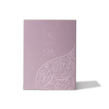 Artist’O Ode Eau de Parfum in an ornate clear glass bottle with a soft ivory fragrance, displayed with pastel pink luxury packaging – Find Online Today