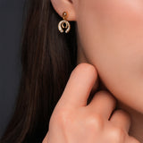 Side profile portrait showing a model wearing the delicate gold-plated Cerruti 1881 Amalia interlocking double C stud earring.