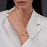 Lifestyle studio photograph demonstrating the delicate drape, dual-strand fit, and high-shine gold finish of the Celeste bracelet on a model's wrist.
