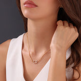 Lifestyle portrait of a model showcasing the scale, drop length, and radiant shine of the gold-plated Cerruti 1881 Bianca crystal necklace.