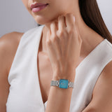 A lifestyle view of the 22mm square Escada watch styled on a female wrist, paired with a sleeveless white blouse to highlight its clean, refreshing, and jewelry-like aesthetic.