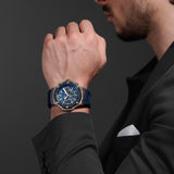 A lifestyle photograph of the Cerruti 1881 Lucardo watch on a man's wrist, styled with a charcoal grey pinstripe suit jacket and white pocket square to show its versatile sport-luxury wearability.