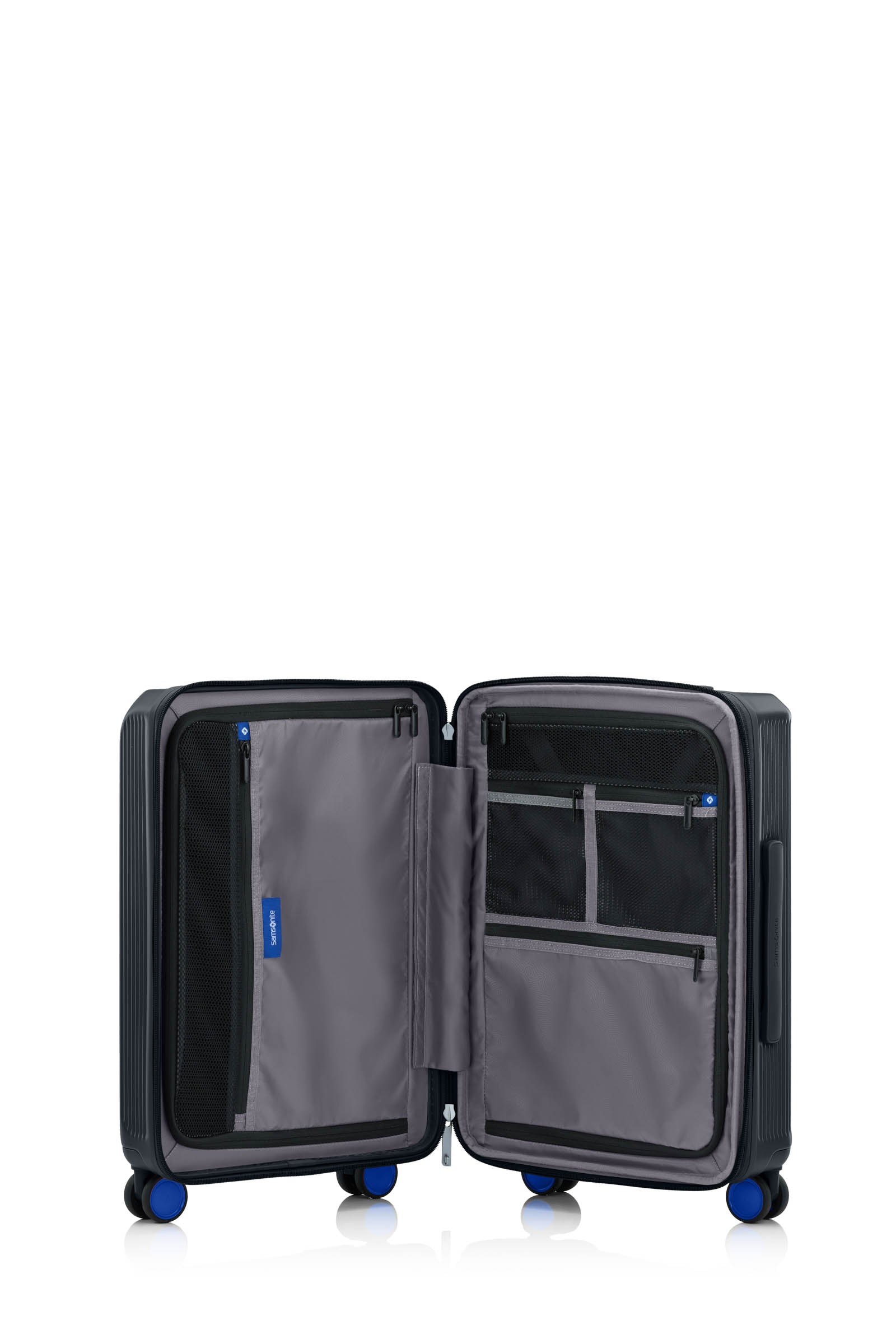 Open interior of the Samsonite Voypod Spinner cabin in Black, revealing the grey recycled fabric lining, height-adjustable packing straps, and dual zippered divider pads. Available for Online Purchase