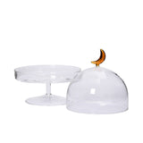 Open lid view of the Favorite Glass clear cake stand with glass dome and amber moon handle. Shop Now Online