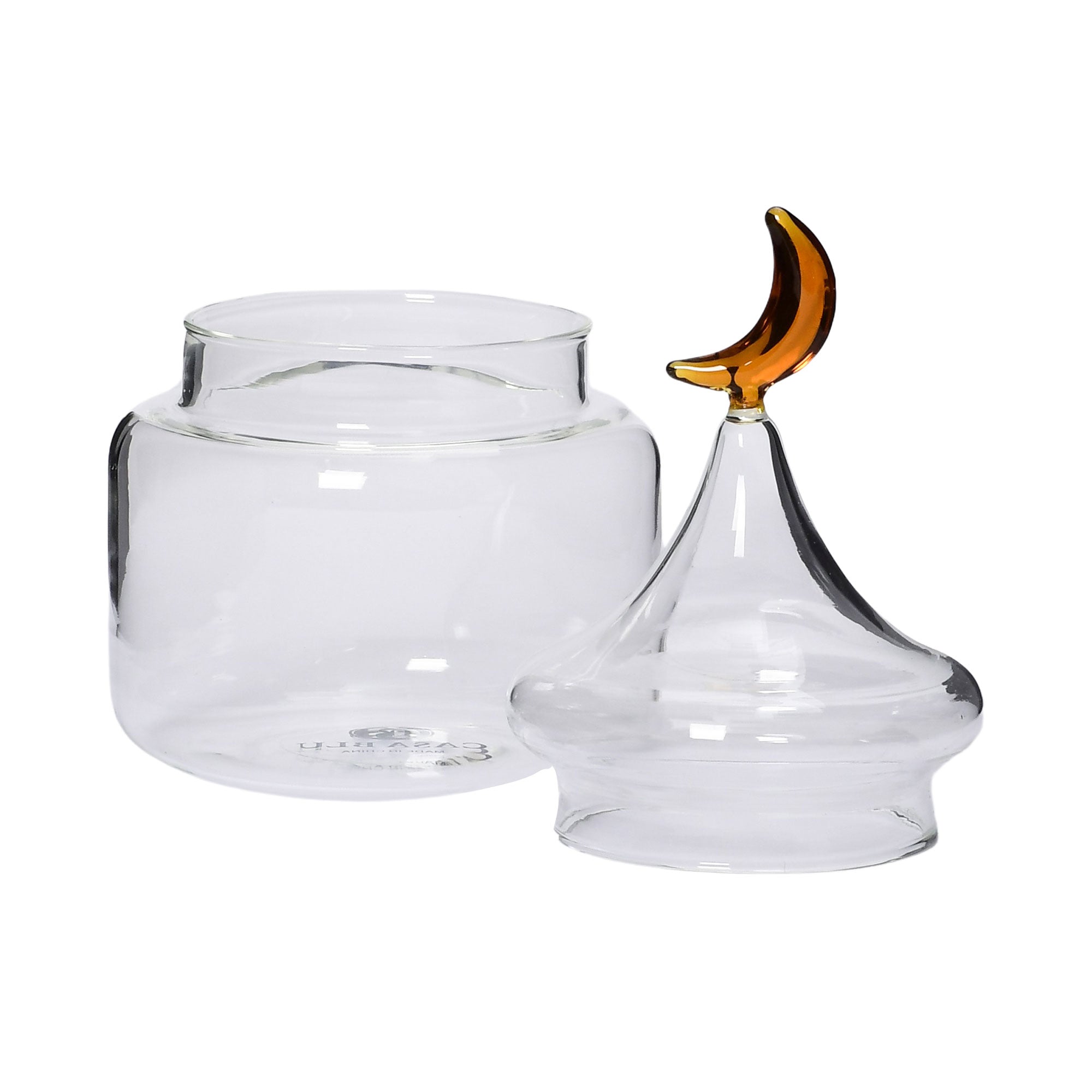 Open lid view of the Favorite Glass clear decorative storage jar with dome lid and amber moon handle. Shop the Collection Online