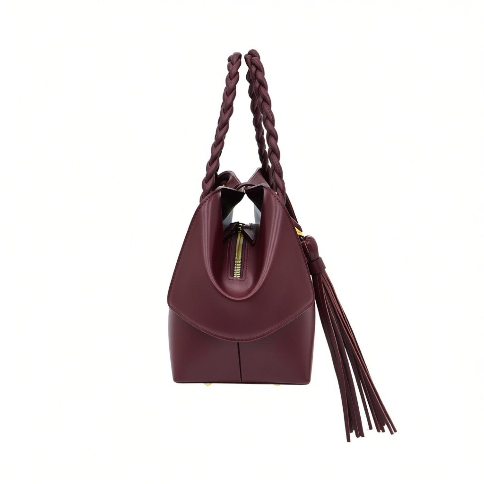 Side profile view of the burgundy leather handbag showcasing its winged structure, zippered main closure, gold-tone hardware accents, and the side drop of the braided handle, available at BLUE SALON.