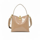 Front view of a beige patent leather shoulder bag with a gold-tone clasp closure, available at Blue Salon.