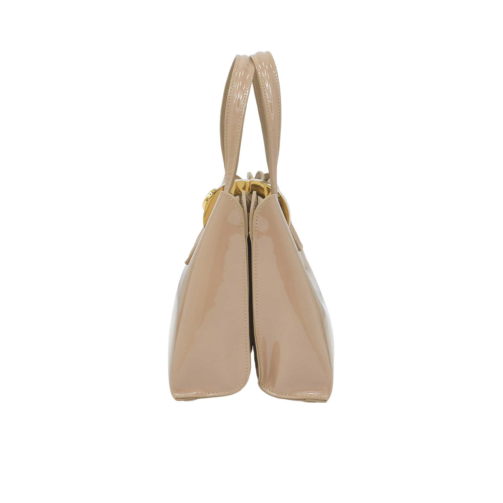 Beige handbag with a gold clasp on a white background.