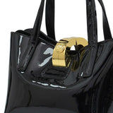 Black patent leather handbag with a gold clasp on a white background.