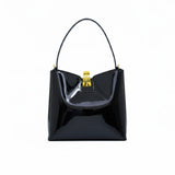 Front view of a Black patent leather shoulder bag with a gold-tone clasp closure, available at Blue Salon.