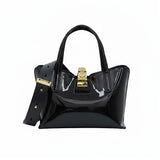 Black handbag with gold accents on a white background.