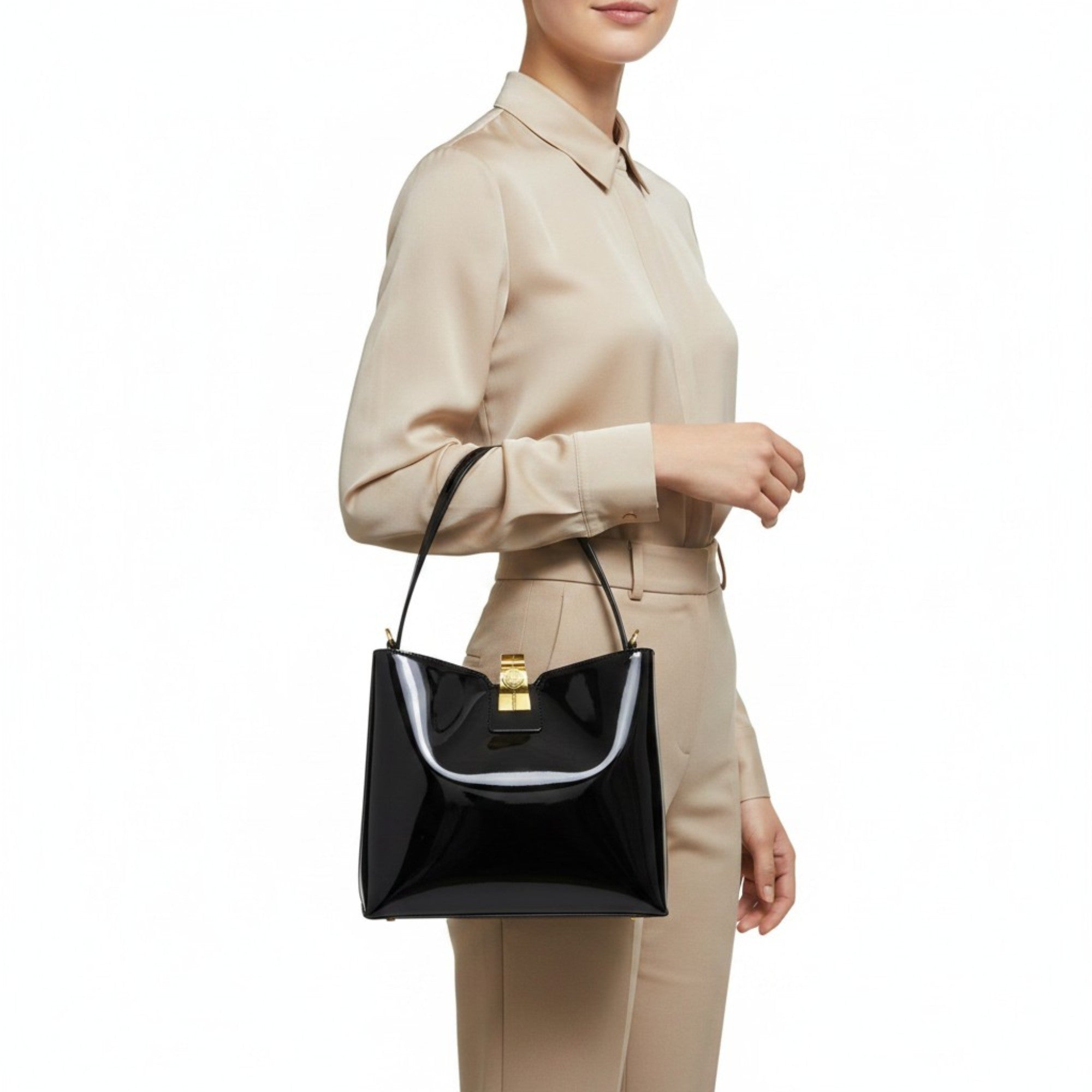 Person holding a black handbag with a white interior on a white background.