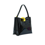 Three-quarter perspective view of the glossy Black patent leather handbag, showcasing its gold-accented hardware.