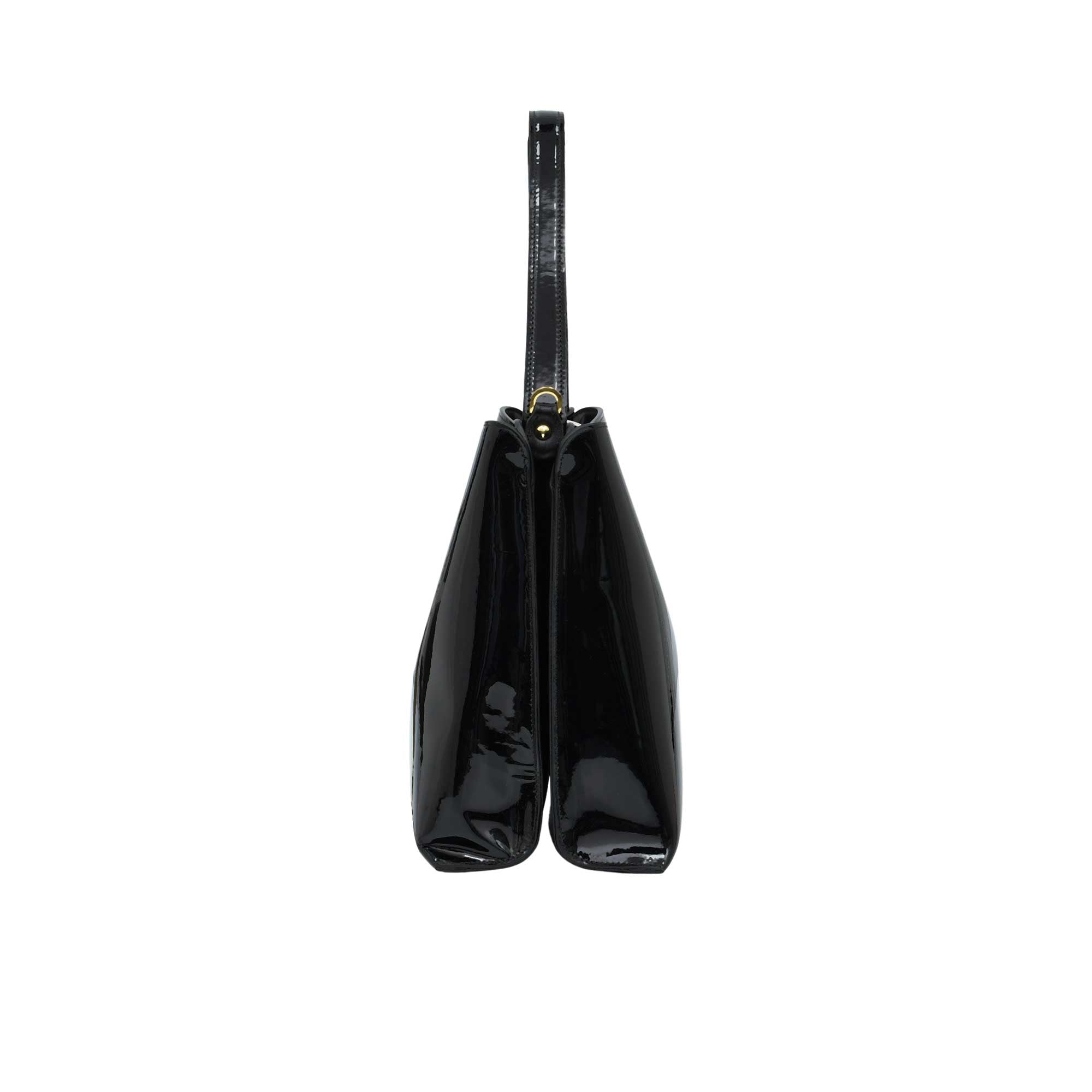 Side profile view of the sleek Black patent leather handbag showing its structured dual-compartment gusset design.