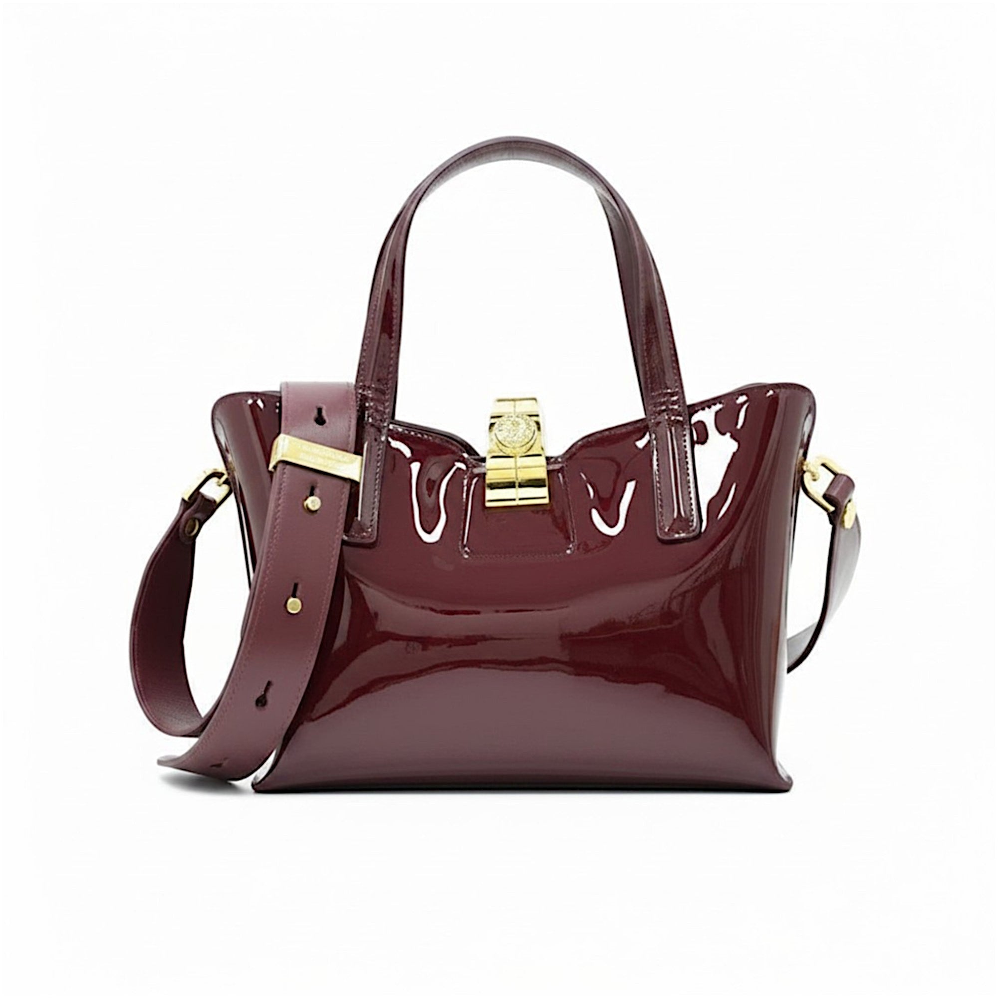 Front view of a burgundy patent leather handbag featuring a structured silhouette, dual top handles, a gold-tone clasp closure, and a wide matching shoulder strap slung across the front.
