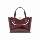 Straight-on back view of the sleek burgundy patent leather handbag, emphasizing its symmetrical stitching and dual top handles.