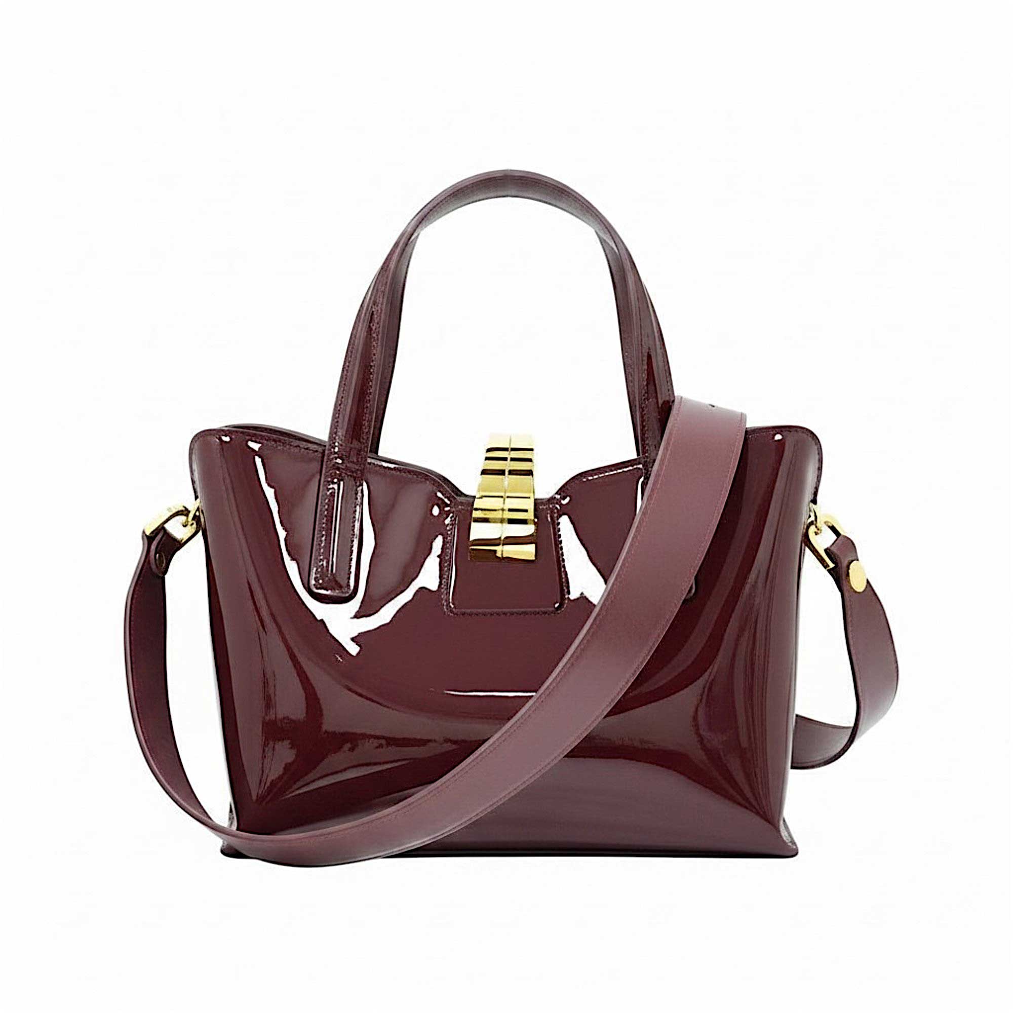 Rear view of the burgundy patent leather handbag, displayed with its detachable matching leather shoulder strap neatly rolled and resting in front.