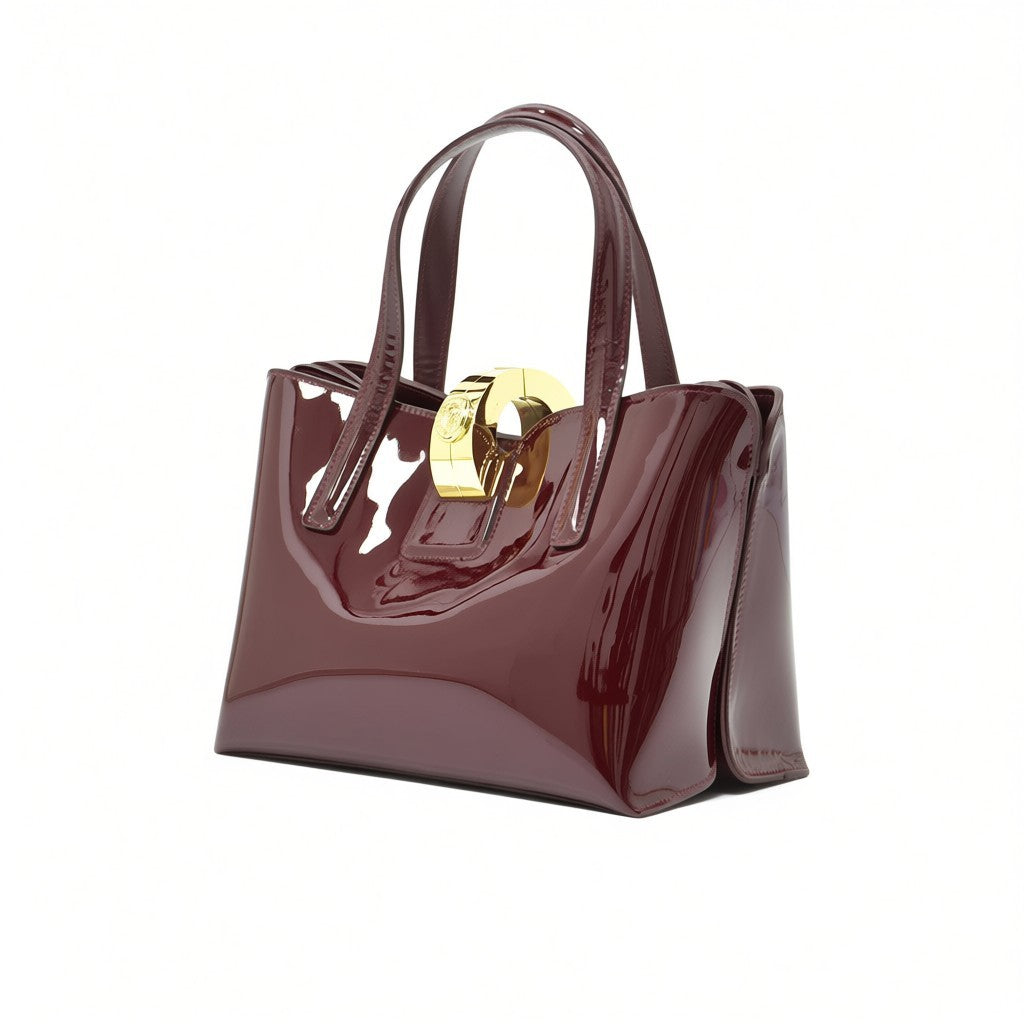 Three-quarter right angle view of the glossy burgundy handbag, showcasing its reflective patent finish and structured side gusset.