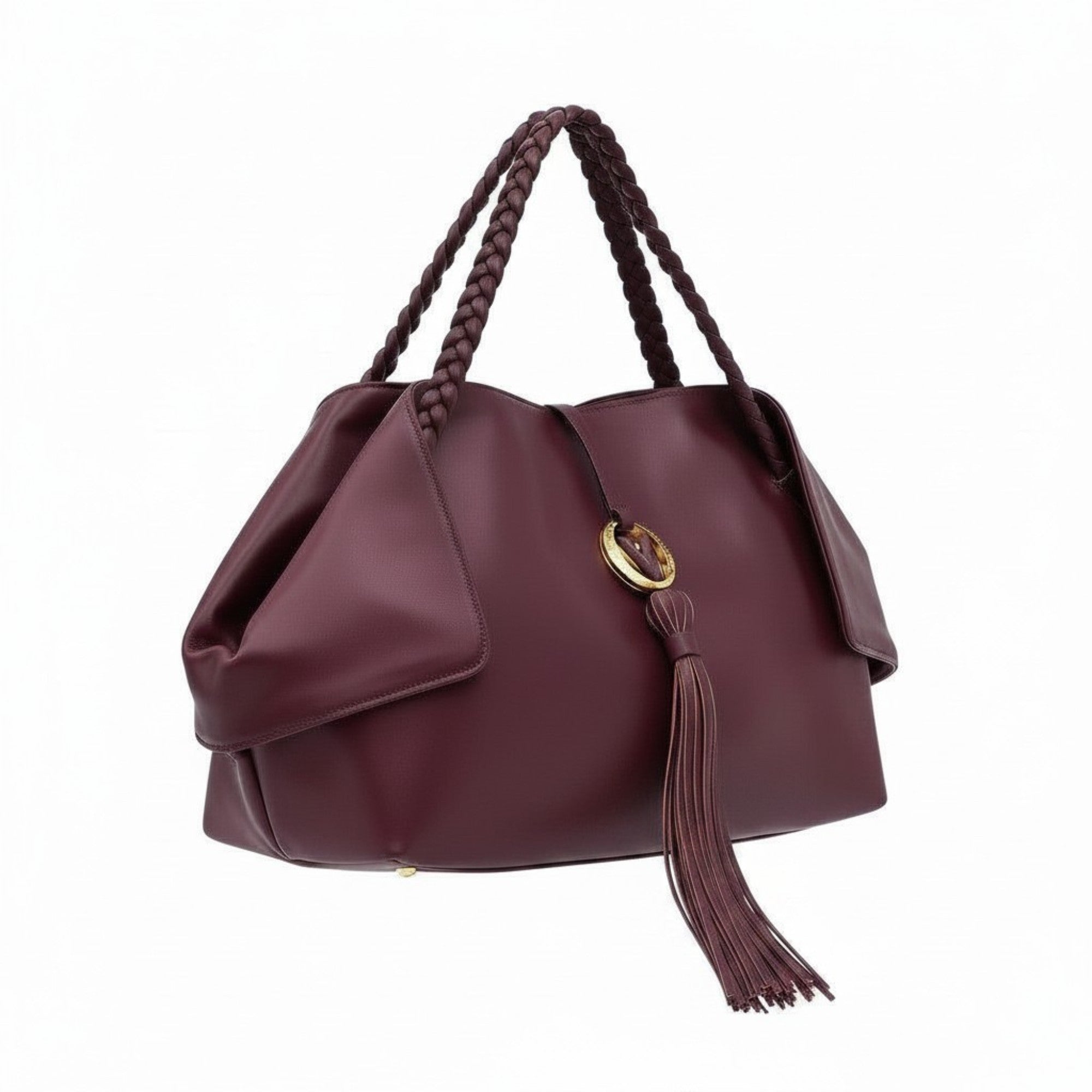 Three-quarter right angle view of the burgundy leather handbag, highlighting its unique folded side panels and long leather tassel.