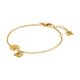 A full studio product photograph of the Escada Margarete charm bracelet, showing the gold-plated cable chain, the integrated seashell focal station, the dangling monogram charm, and the lobster clasp closure.