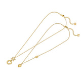 A side-by-side close-up studio presentation of the Escada Mia set, showing the larger gold-plated heart-cutout disc suspended from a crystal-lined EE logo charm, and the smaller solid puffy heart pendant with its unique integrated chain monogram station.
