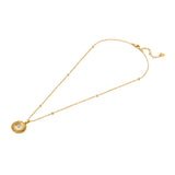 A full three-quarter studio product presentation of the Escada Naomi necklace, showing the gold-plated cable chain with crystal station inserts, the central round layered cutout medallion pendant, and the lobster clasp enclosure.