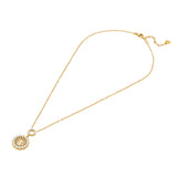A full three-quarter studio presentation of the Escada Clara necklace, displaying the yellow gold-plated cable chain linked to a tiered pearl ring station and a crystal-haloed monogram medallion pendant.