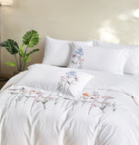 The crisp white duvet cover and matching shams create a bright, airy, and sophisticated atmosphere.