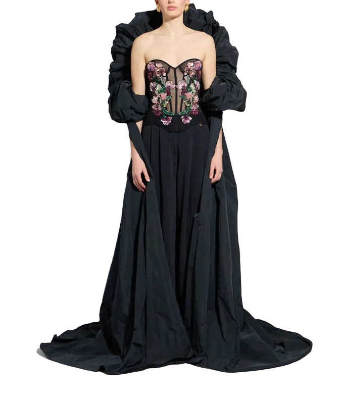 Black strapless corset top with colourful floral embroidery, black flowing skirt, and voluminous black puffed shoulder cover.