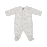 Petit Bateau baby footed onesie in off-white with a small, all-over grey heart print and front snap closures.