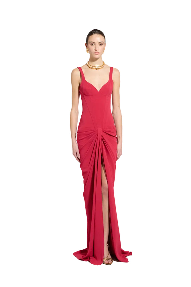 Persian red floor-length gown with a fitted V-neck bodice, wide straps, ruched waist, and a high front slit.