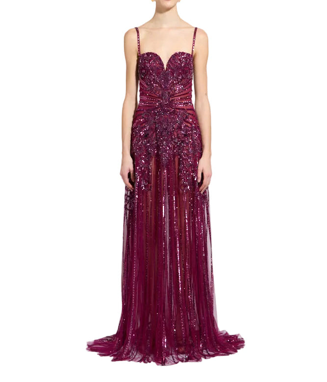 Magenta sequined gown with sweetheart neckline, spaghetti straps, and a floor-length sheer skirt with vertical sequin lines.