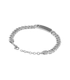 Silver-toned curb chain bracelet with a rectangular bar featuring a textured pattern and a stylized 'P' logo. Lobster clasp w
