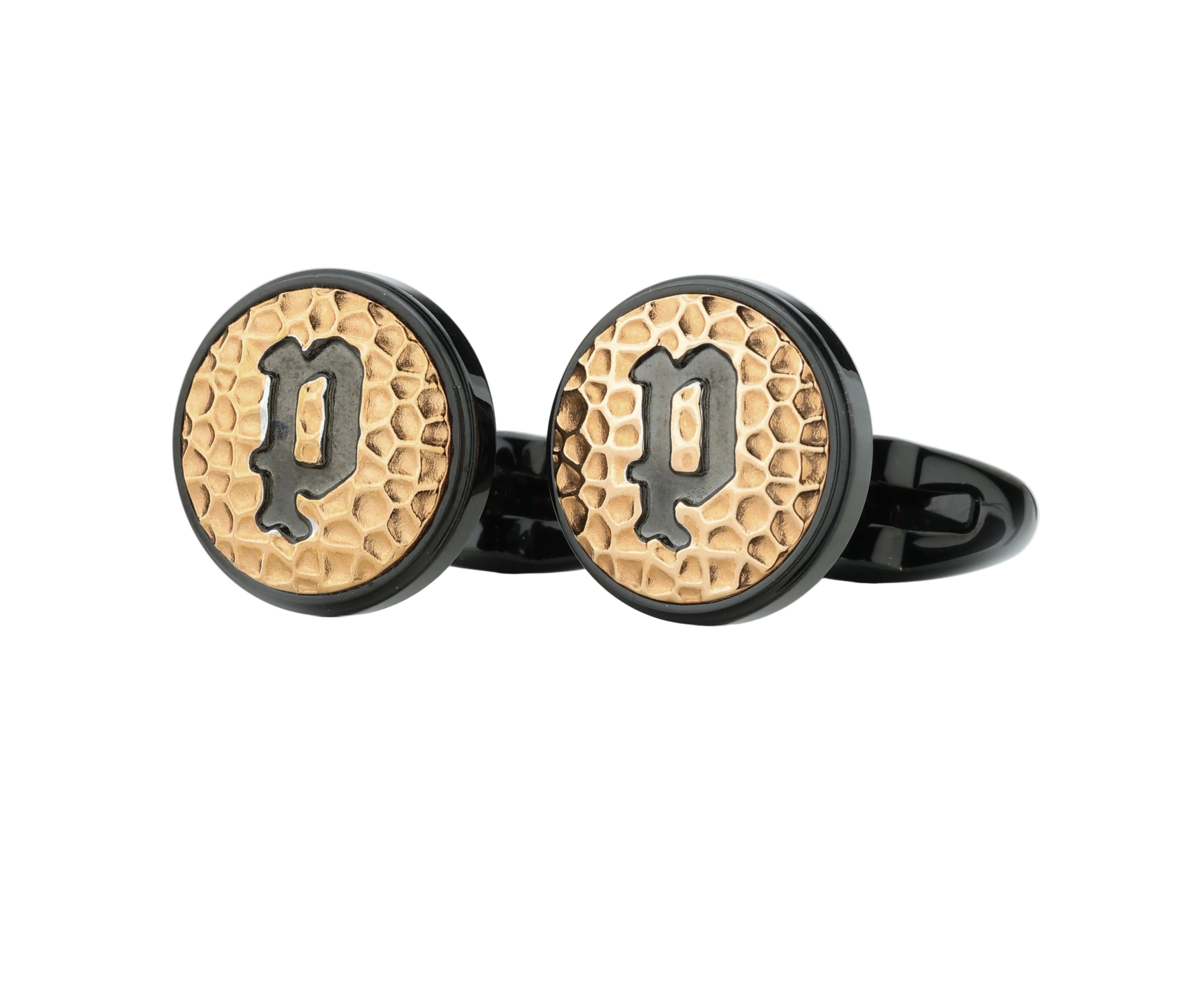 Pair of round cufflinks with a black border, a gold-toned hammered centre, and a raised black letter 'P'.