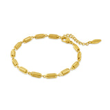 Gold-toned bracelet with elongated, ribbed capsule links and an extender chain with a "POLICE" charm.