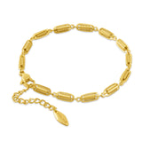 Gold-toned bracelet with elongated oval links, each containing a coiled spring design. Lobster clasp and extension chain with