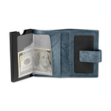 Open navy leather automatic card case with a black card holder, clear sleeves, multiple card slots, and a snap closure tab.