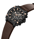 Black angular watch with gold-toned case accents, a black chronograph dial, gold-toned markers/hands, and a brown leather str