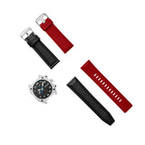 Silver-toned watch with gunmetal dial, plus interchangeable black leather and red silicone straps, each with a silver-toned b