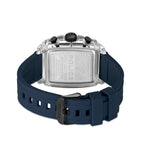 Back view of a watch with a clear case, silver-toned backplate, and dark blue silicone strap with a black buckle.