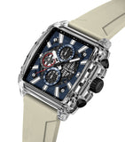 Clear rectangular watch with a blue textured dial, black sub-dials, white markers, black pushers, and a beige silicone strap.