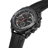 Gunmetal black watch with a black chronograph dial, silver-toned markers, red accents, and a textured black silicon strap.