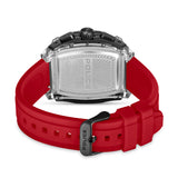 Rectangular watch with a black case, silver-toned engraved metal back, and a red silicone strap with a black buckle.